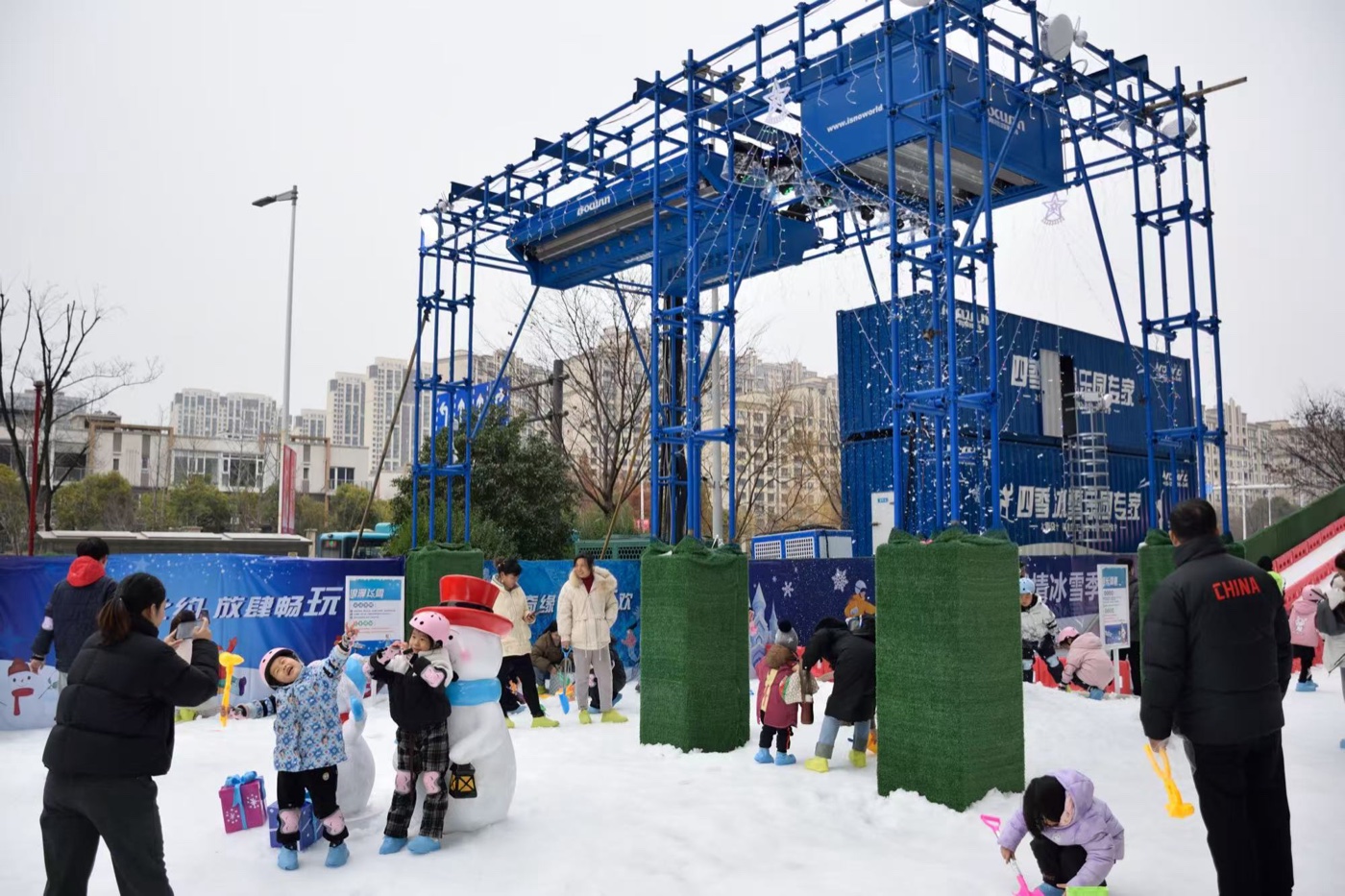 Outdoor snow park with family play areas and artificial snow coverage