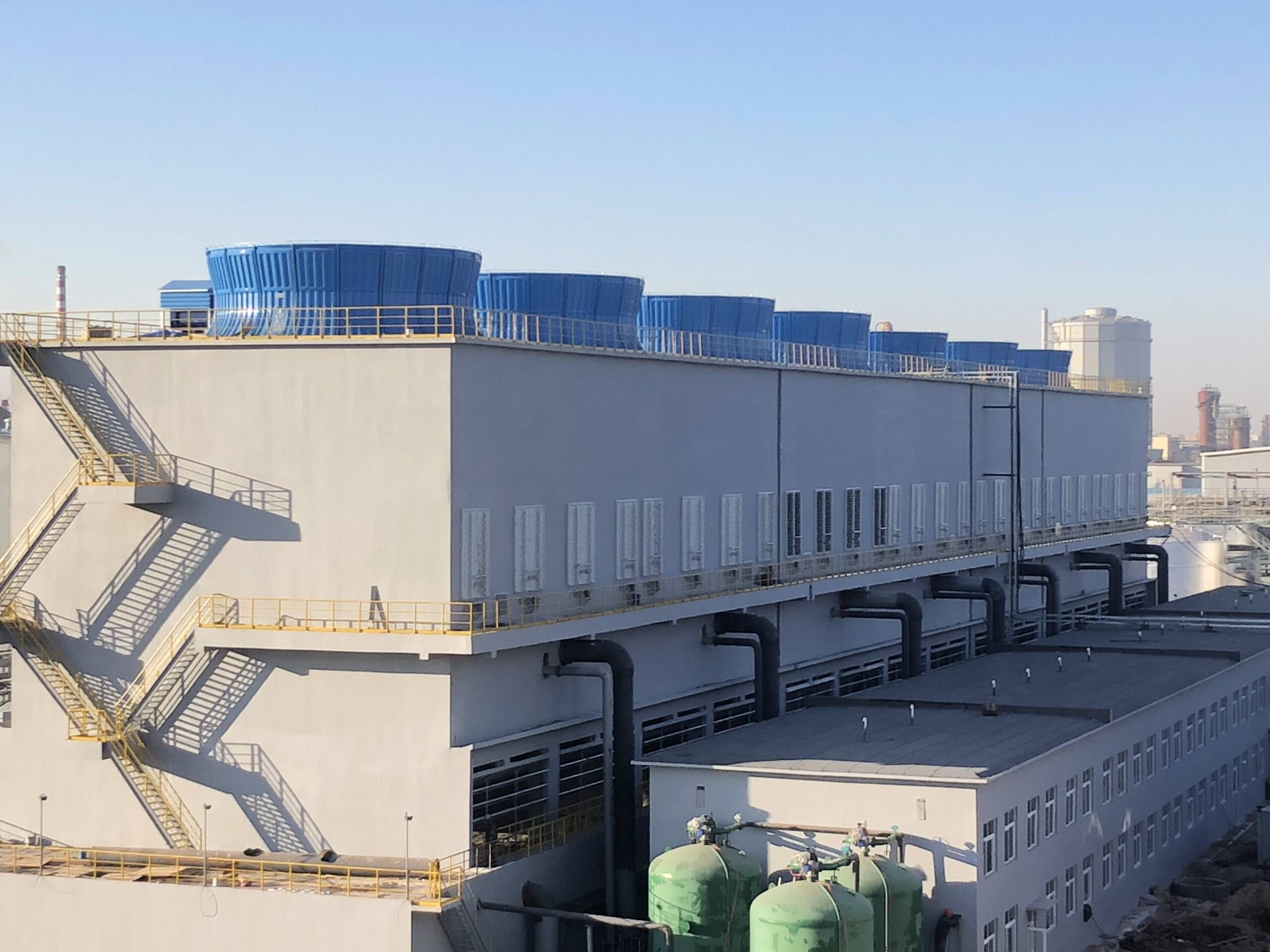 Industrial cooling towers and process refrigeration equipment on a factory rooftop