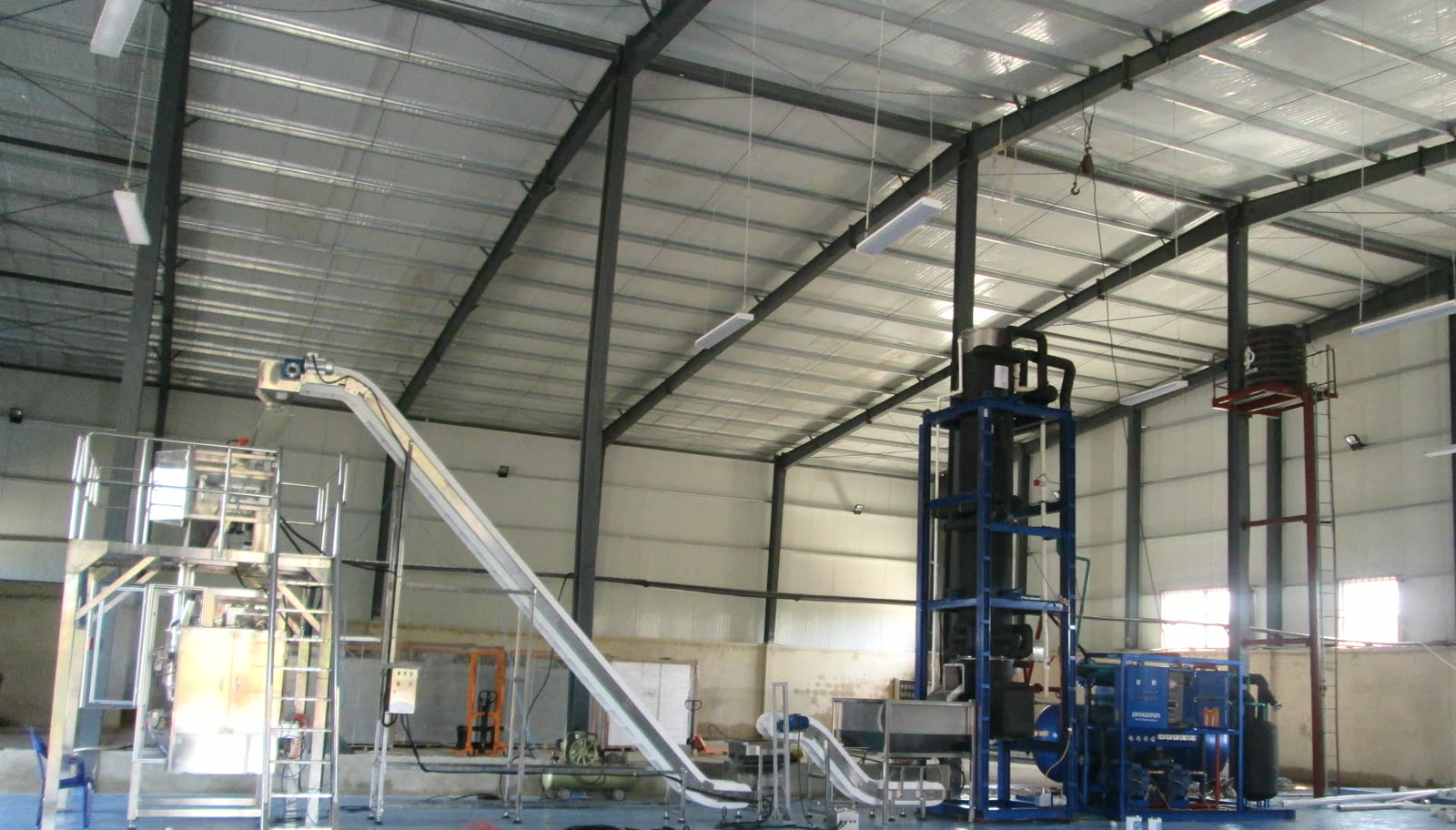 Automatic ice packing line with refrigeration equipment in industrial workshop