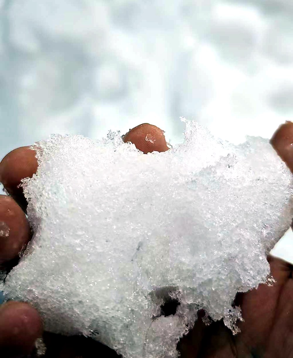 Closeup of dry fluffy artificial snow made by supercooled water crystallization